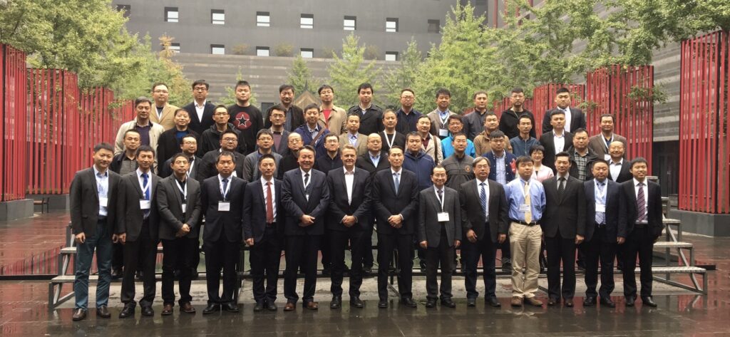 Group photo of neurosurgery delegates in a courtyard, with Dr Gert Tollesson in the front row